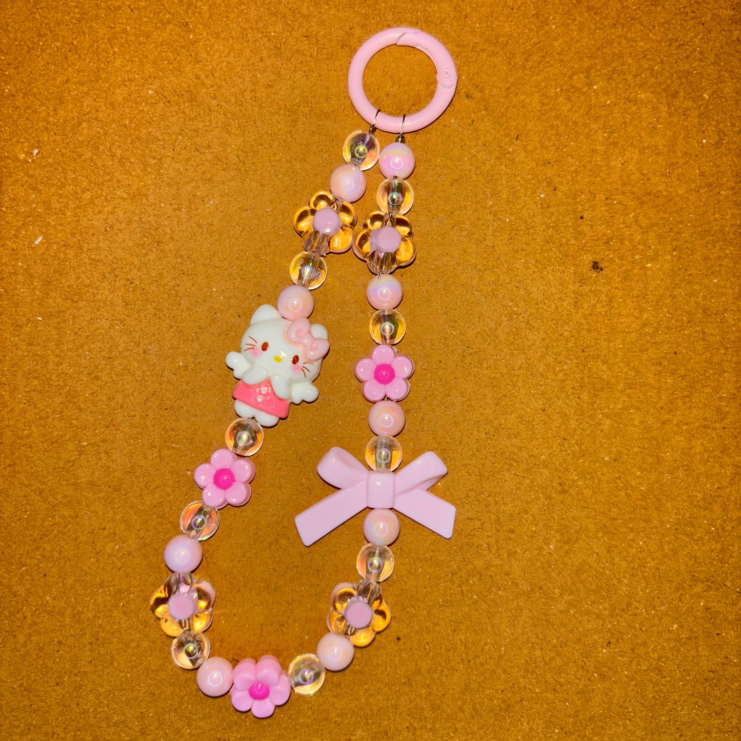 Decorative keychain with flowers and a cross on a brown background