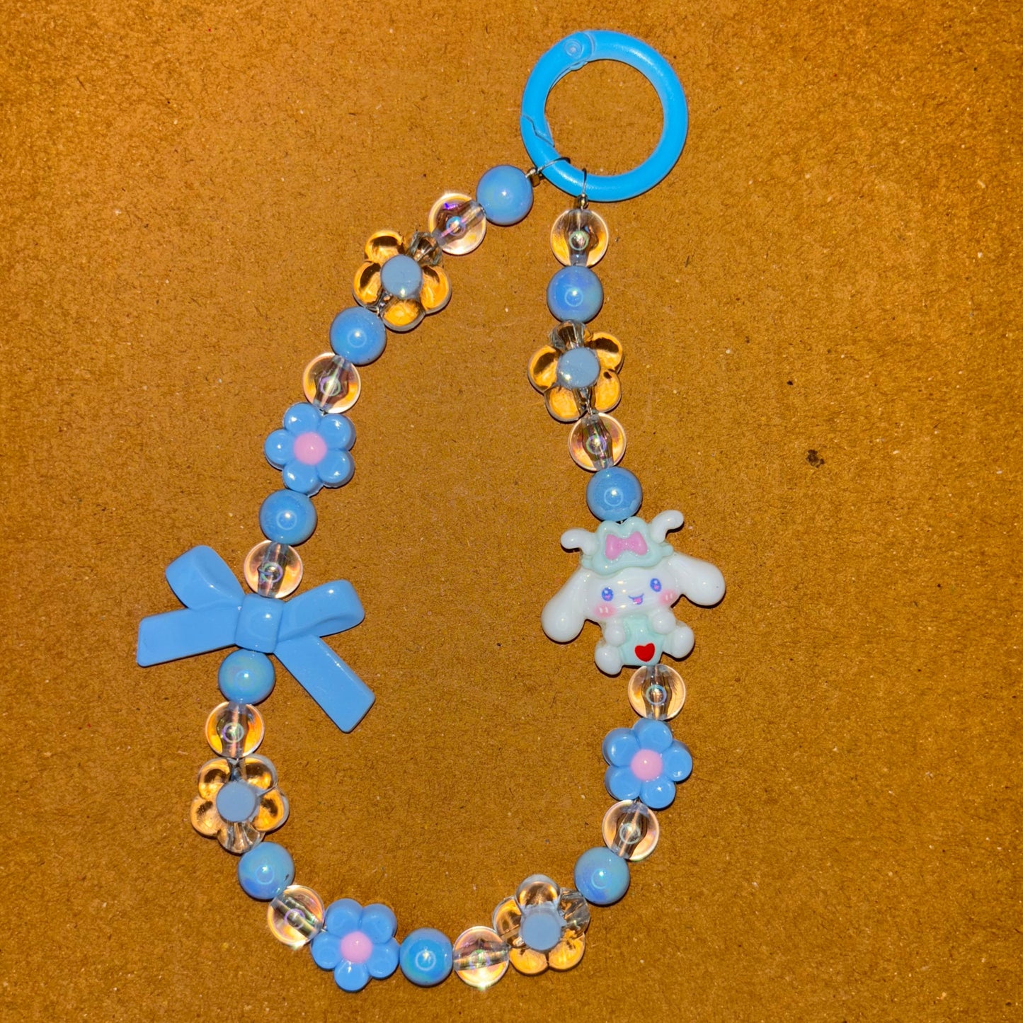 Children's bracelet with blue, gold, and silver beads on a brown background
