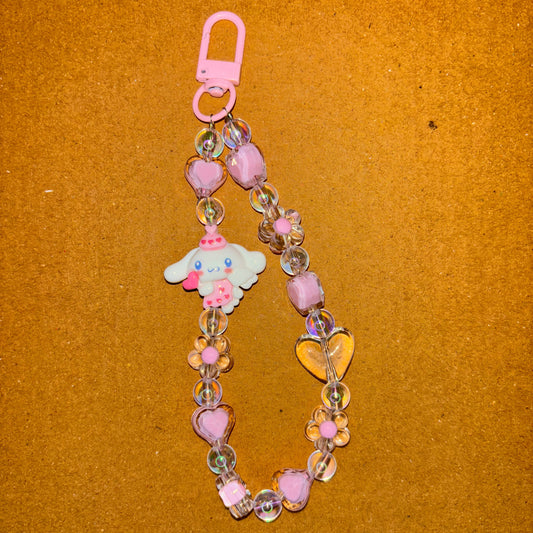 Colorful beaded lanyard with a cartoon character charm on a brown background