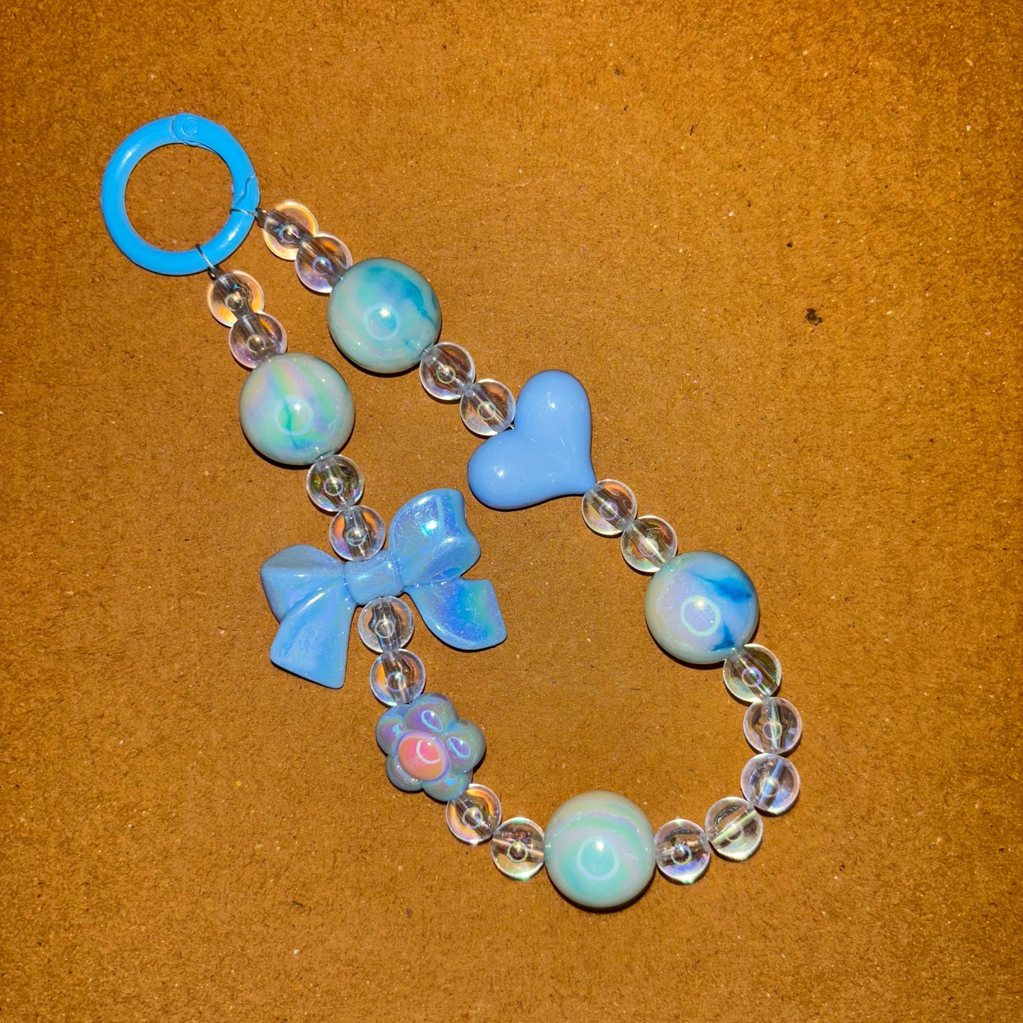 Bracelet with blue and clear beads on a brown background