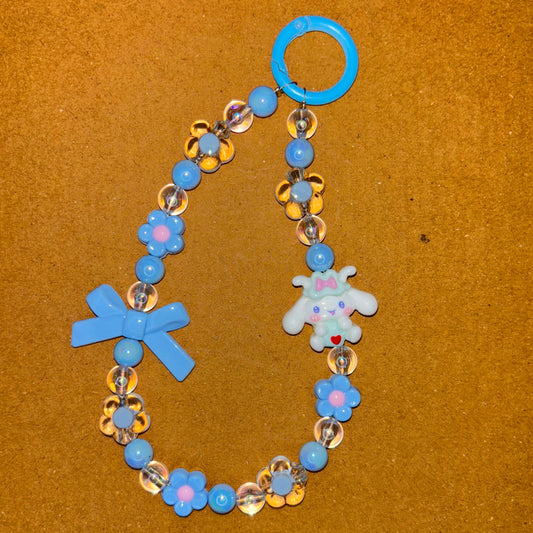 Children's bracelet with blue, gold, and silver beads on a brown background