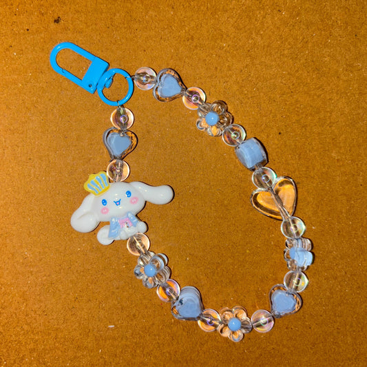 Bracelet with a blue clasp and heart-shaped charm on a brown background