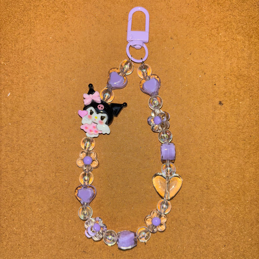 Bracelet with a cat charm and flowers on a brown background