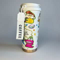 Colorful coffee cup with cartoon designs and a 'COFFEE' tag on a white surface.